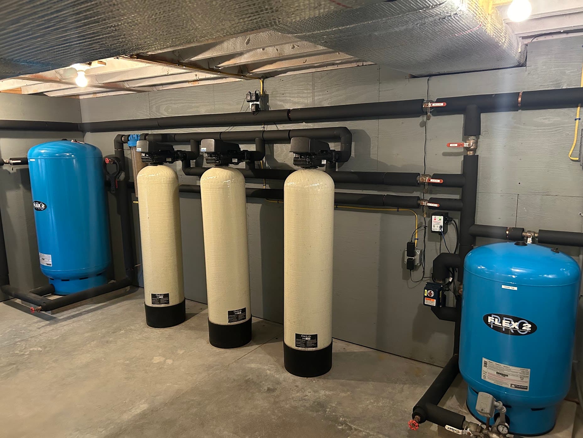 A whole-home water filtration and softening system